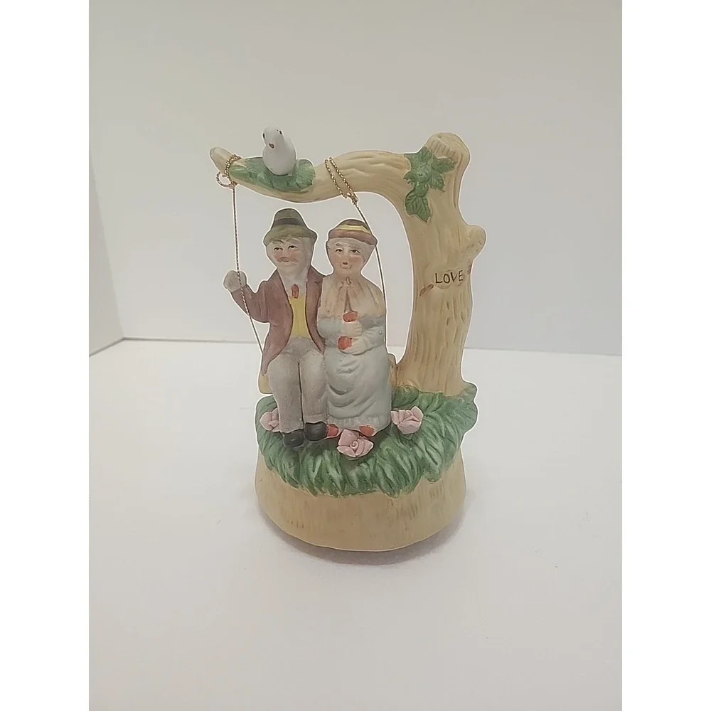MSR Imports Inc. Porcelain Music Box Elderly Couple on Swing. Writing On Bottom